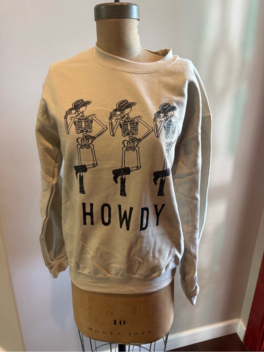 Halloween Beige Crewneck Sweatshirt with Black Skeleton Howdy Graphic